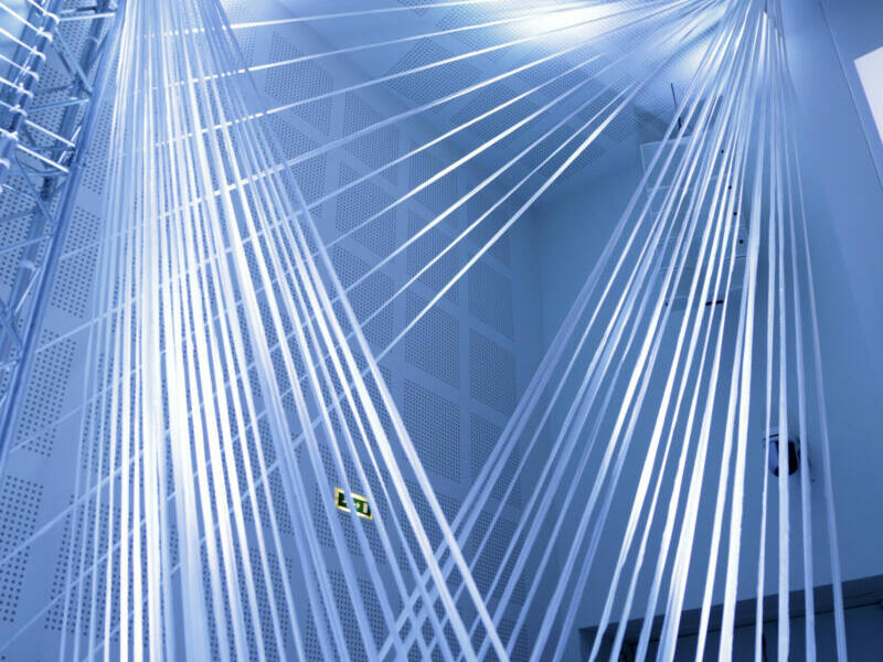 Installation lumineuse blanche et bleutée contemporaine en intérieur.
