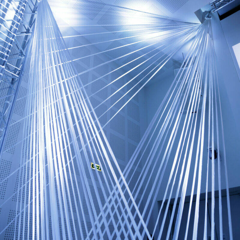 Installation lumineuse blanche et bleutée contemporaine en intérieur.